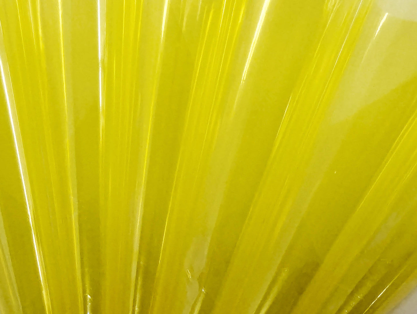 Close up of translucent yellow cello flats rolled into cones