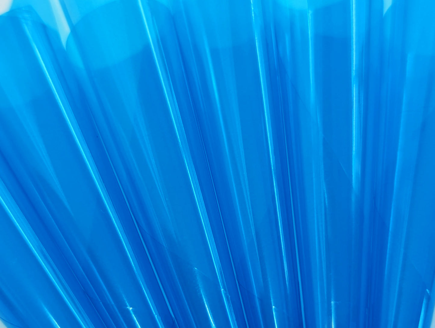 Close up of translucent cyan blue cello flats rolled into cones