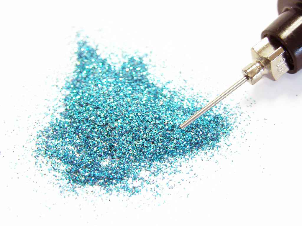 Light sky blue glitter, cosmetic grade - close up picture of loose glitter with poof bottle tip