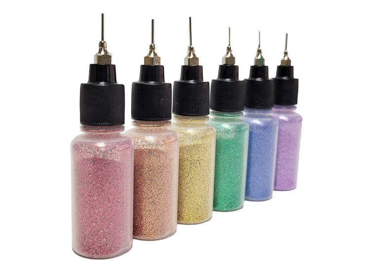 Glitter poof bottles in all six rainbow colors