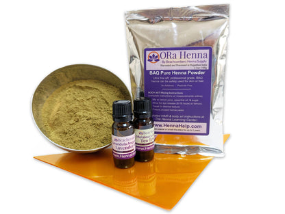 Picture of 100g bag of BAQ ORa henna powder with a bottle of tea tree oil and lavender oil with a bowl of henna powder - Henna Refill Kit