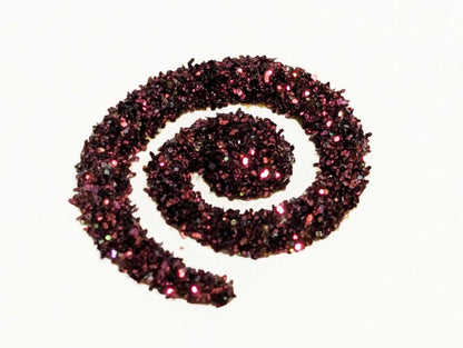 Decorative spiral  of blood moon burgundy glitter on a white background