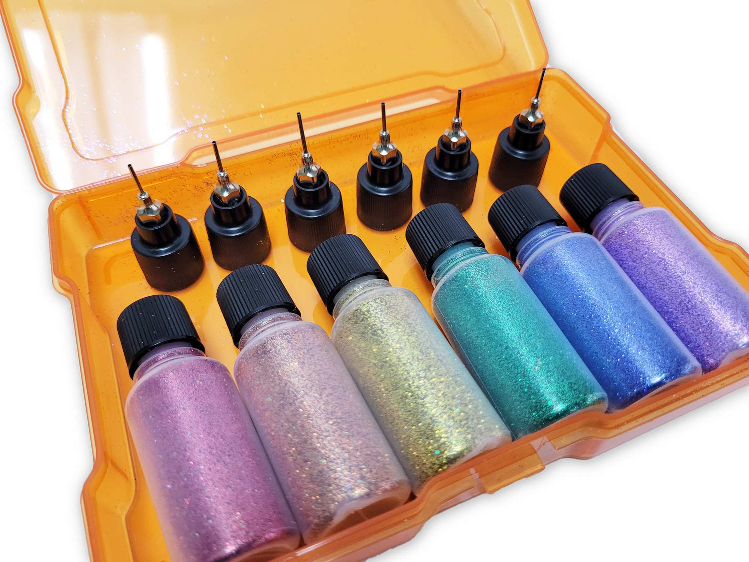 Close up pic of 6 bottles of glitter in rainbow colors nestled in a storage box