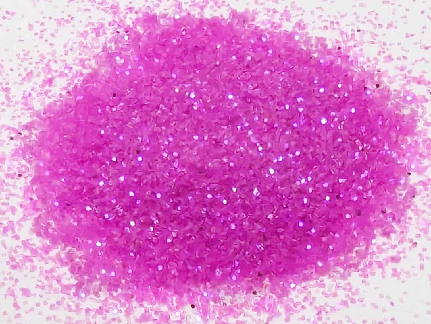 Small pile of UV cosmic berry pink body glitter