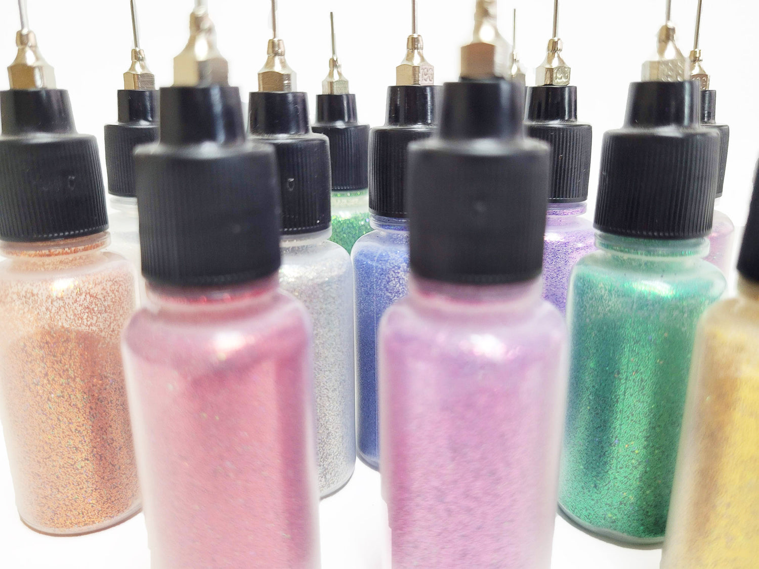 Group of body safe glitter in bottles with metal tips for henna application