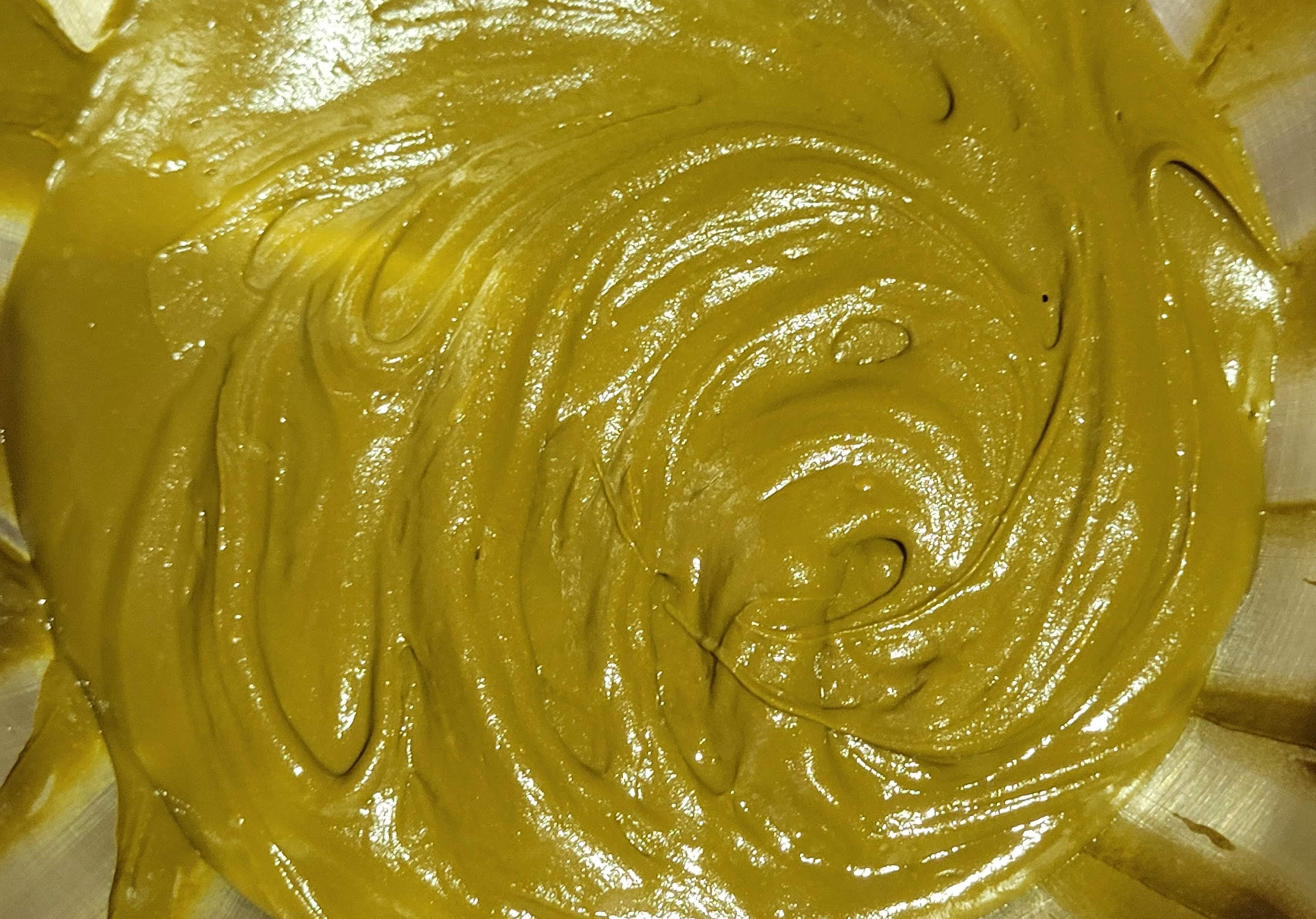 Freshly mixed henna paste in a metal bowl