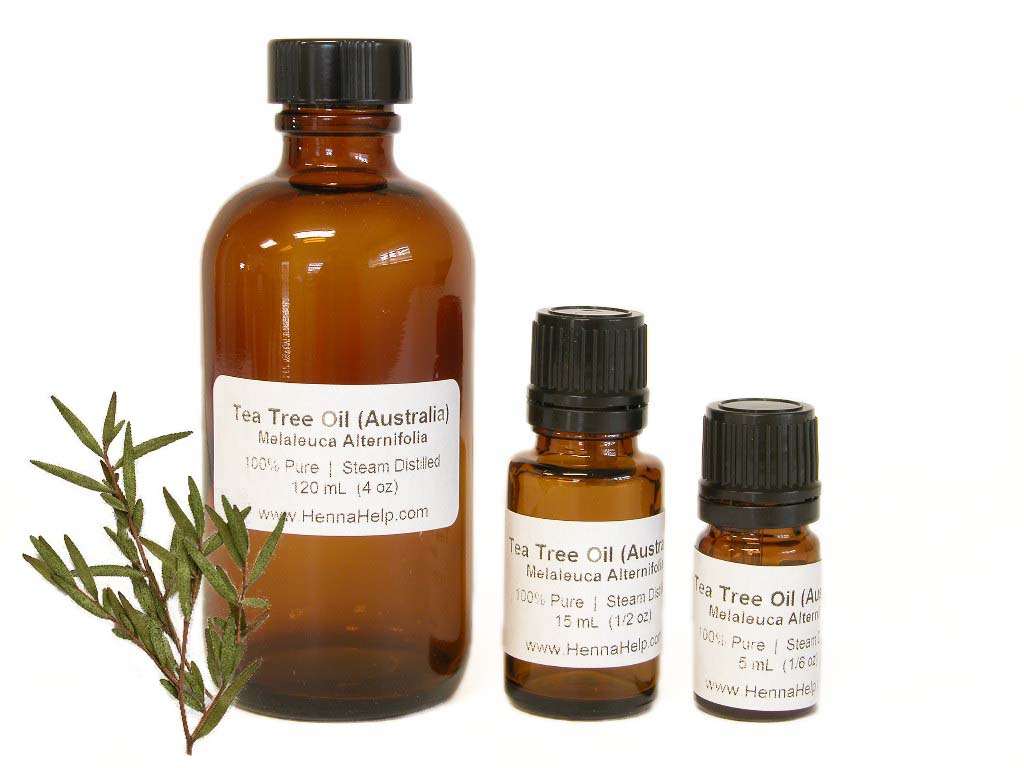 Three bottles if tea tree essential oils in descending size, 120ml, 15ml, and 5ml